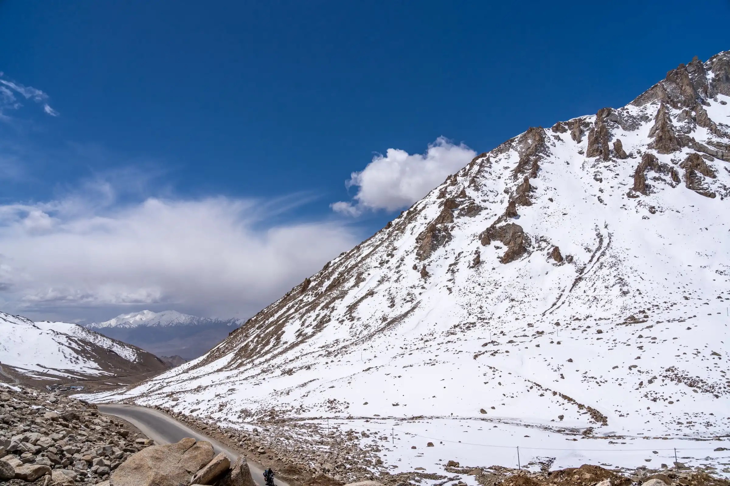 A road winding across a snow-covered slope near Leh